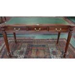 A reproduction mahogany desk, green leather writing surface, three drawers,