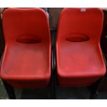 A set of twelve stacking chairs, plastic seats,