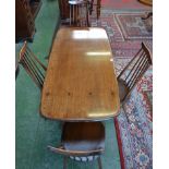An Ercol dining table and four Ercol spindle back chairs
