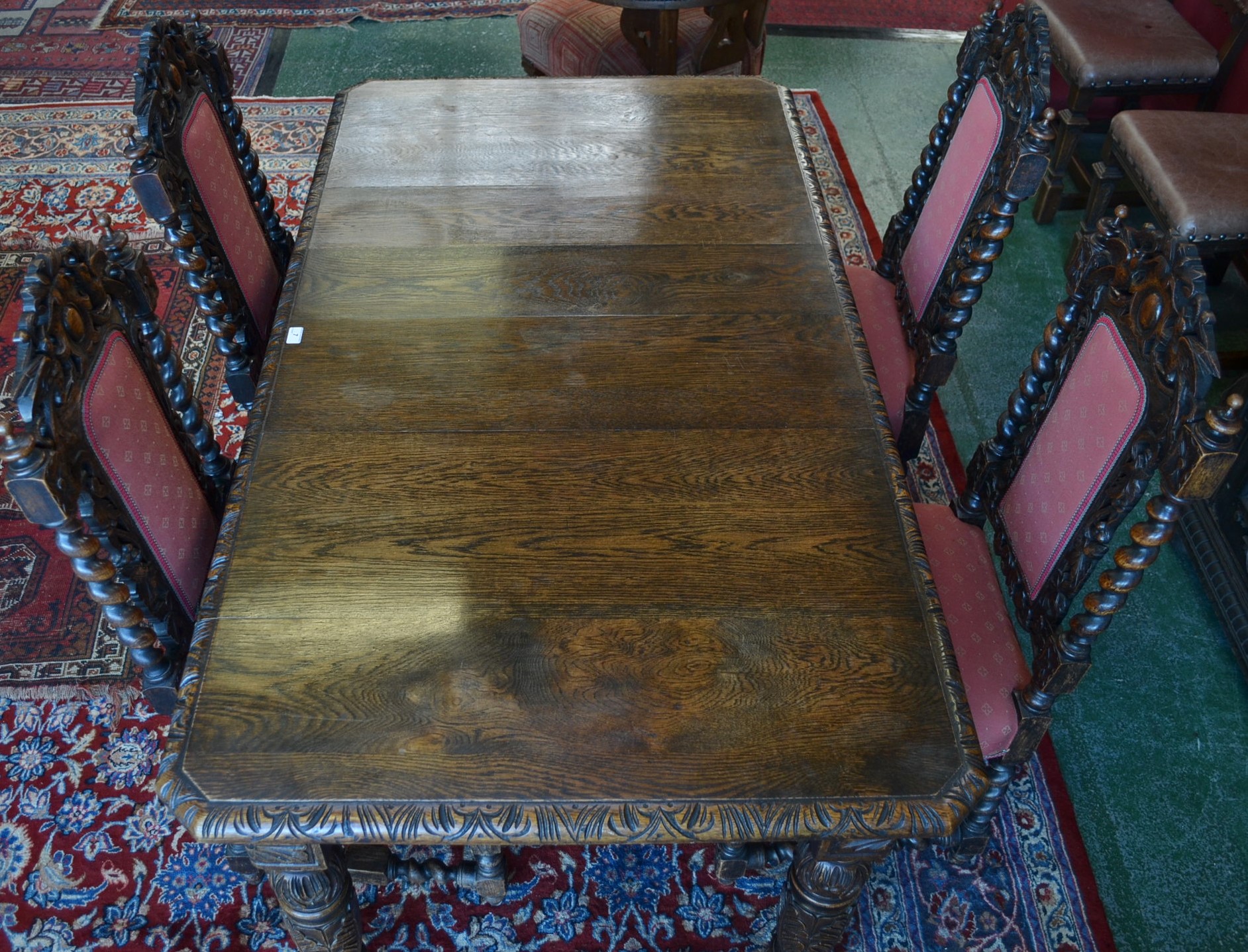 A Victorian oak wind out dining table; additional leaf; a set of four oak dining chairs,