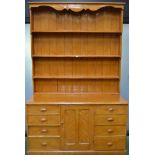 A Victorian Farmhouse scumbled pine dresser, shelves over a central cupboard door,