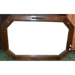 An oak octagonal framed mirror