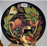 A Moorcroft Queens Choice pattern plate, 26cm diameter; another, Anna Lily pattern ovoid vase,