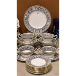 A Wedgwood Florentine pattern part dinner service comprising dinner plates, dessert plates,