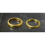 A 22ct gold hoop wedding band, size M; another N, (2) 9.