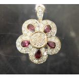 A 9ct gold white sapphire and amethyst flowerhead pendant,