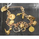 A 9ct rose gold charm bracelet, ten assorted 9ct gold and yellow metal charms, padlock clasp, 17.