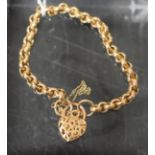 A gold ring link bracelet, fancy pierced padlock clasp, 9.