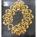 A Continental 9ct gold intertwined egg shaped panel bracelet, 13.