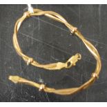 A 9ct gold double twist bracelet, linked by five rings, 7.