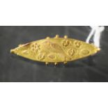 A 9ct gold navette shaped floral and bird decorated brooch, 1.1g, c.