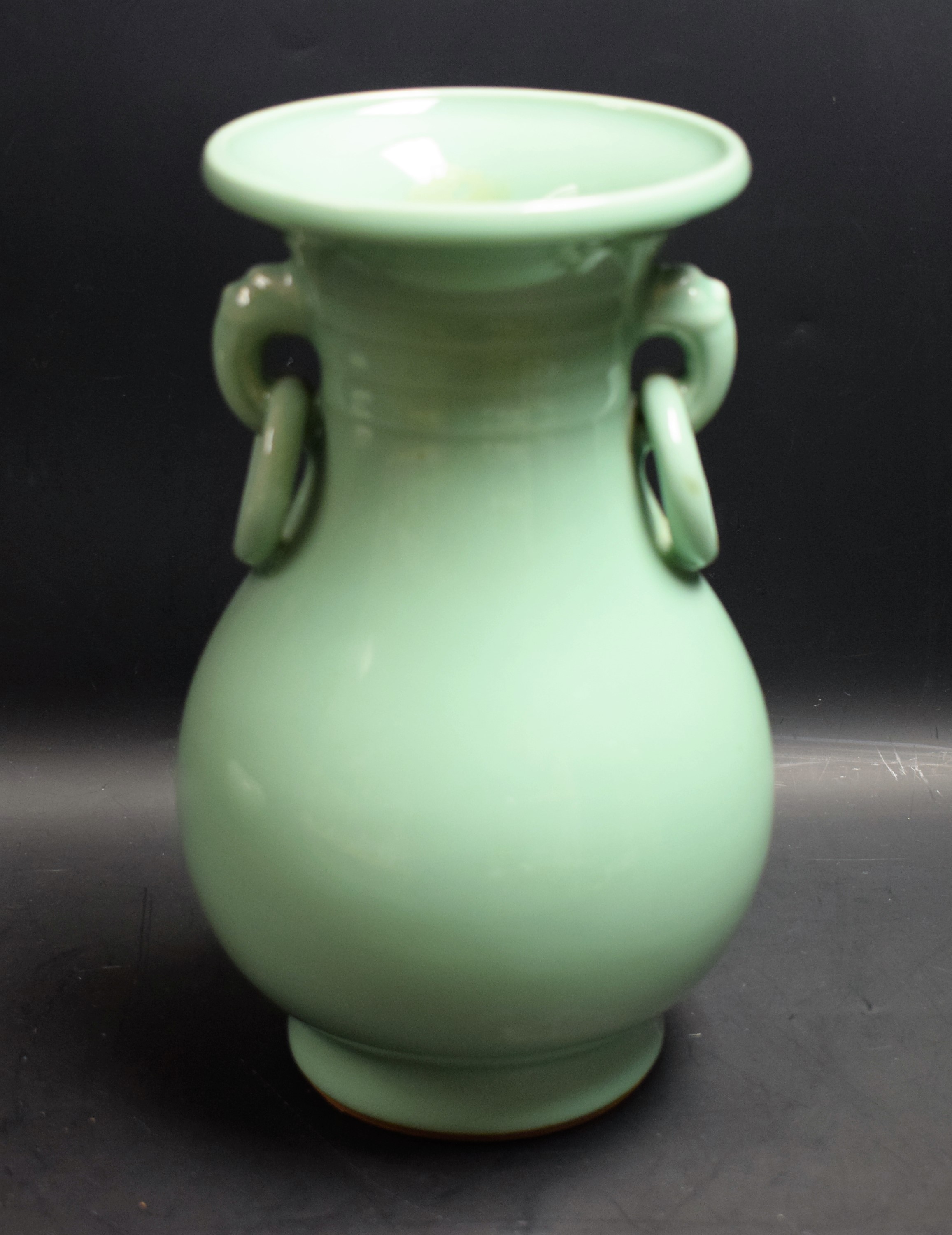 A Chinese celadon ovoid vase, moulded ring handles in the Archaic taste, 24cm high,