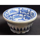 An Oriental circular bowl, painted in tones of underglaze blue with a stylised deer,