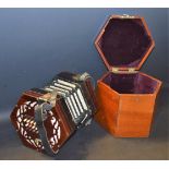 A 19th century forty-eight button concertina, pierced hexagonal ends, leather-trimmed paper bellows,