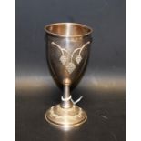 A Jewish silver kiddush or wine cup, the bowl cast in relief with script,