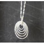 A 9ct white gold pendant necklace, formed from five egg shaped graduated inter-set hoops, 4.