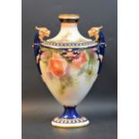 A Hadleys Worcester pedestal ovoid vase, decorated with roses, lion masks flying handles,