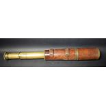 A World War One four-drawer lacquered brass and brown leather field telescope,