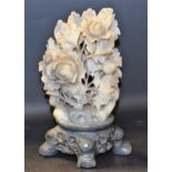 A Chinese soapstone carving, of blossoming peonies, pierced base,