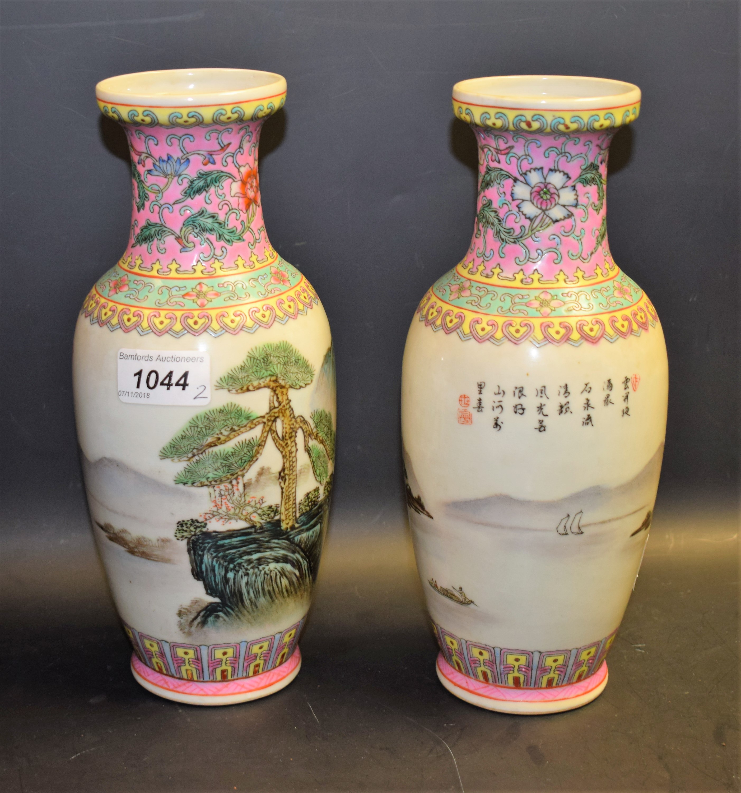 A pair of Chinese Republic Period polychrome vases, decorated with pine tress and rocks,