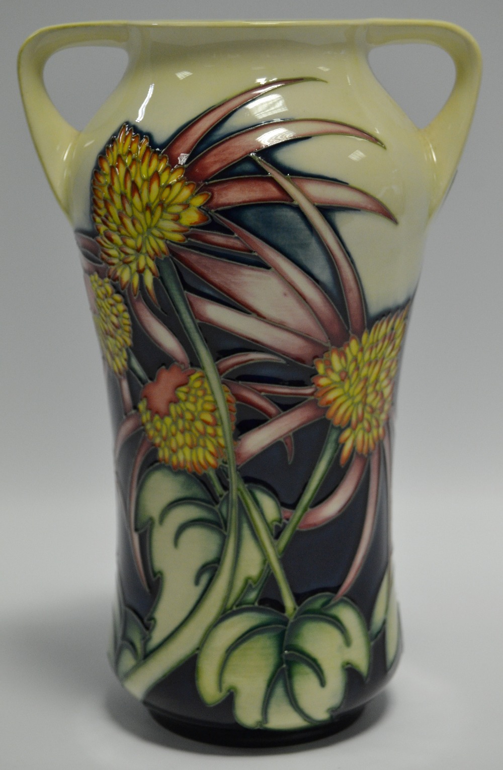 A contemporary Moorcroft Trial two handled waisted vase, tube lined with flowers and foliage,