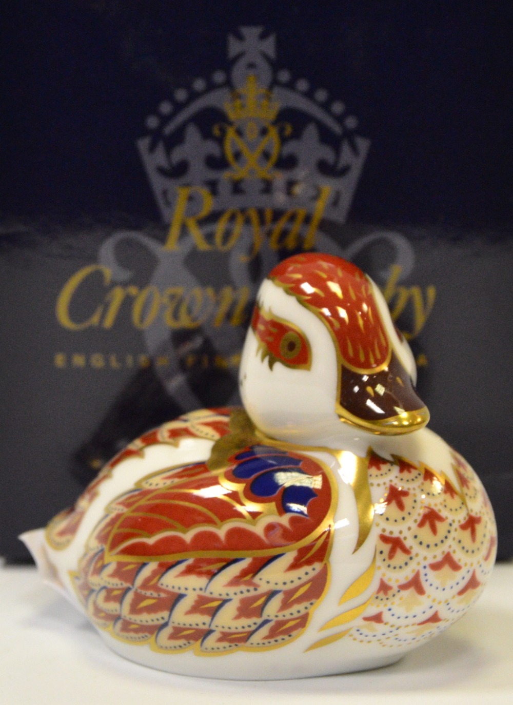 A Royal Crown Derby paperweight, Swimming Duckling, gold stopper,