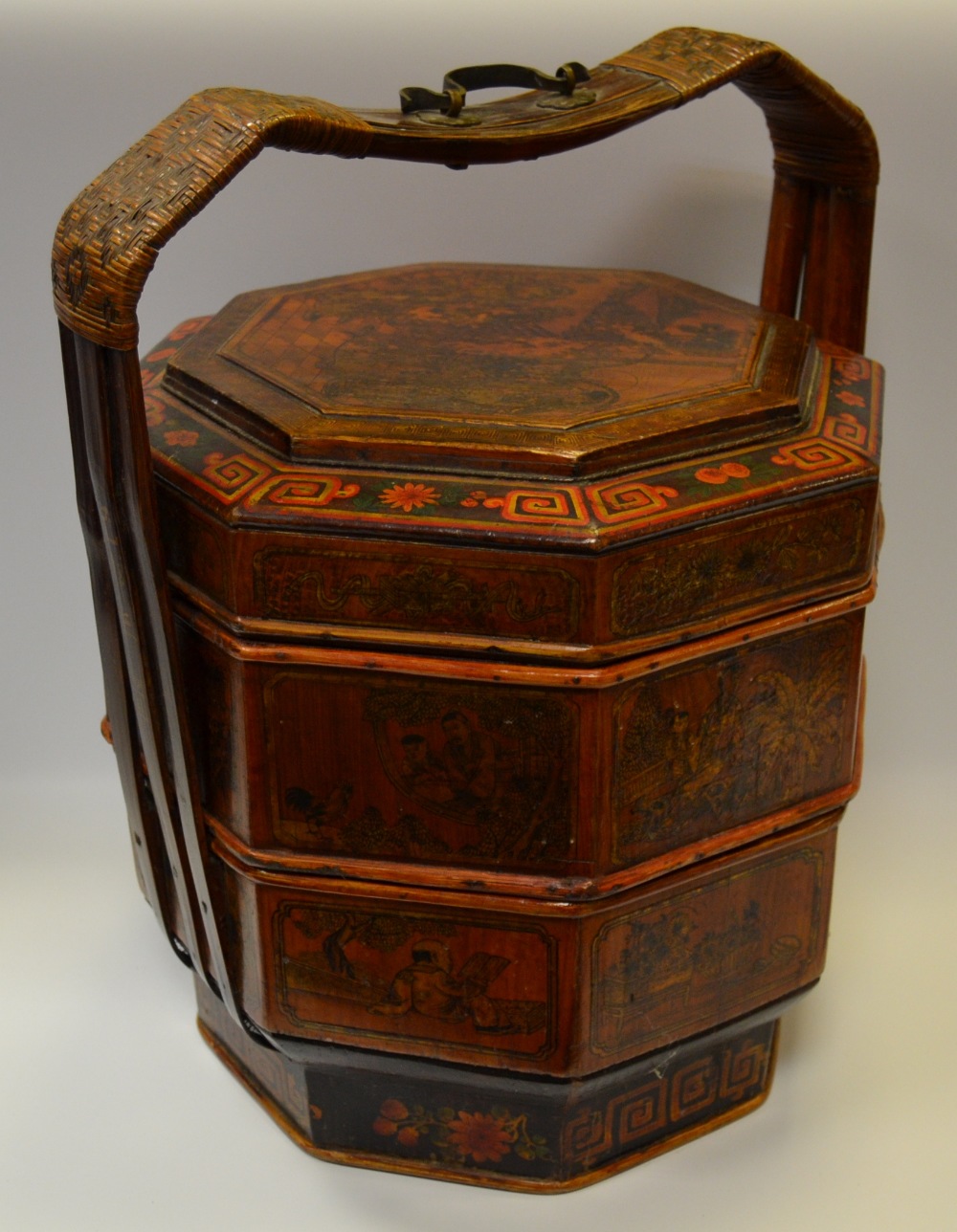 A Chinese octagonal three tier wedding box, shaped handle,