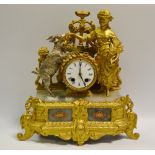 A French gilt metal figural mantel clock featuring a lady hand feeding a silvered goat,