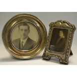 A George V silver circular easel photograph frame, Birmingham 1913; another,