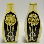 A pair of Black Ryden panelled baluster vases, decorated with stylised flowers on a black ground,