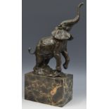 French School, a brown patinated cold cast sculpture, of an elephant, trunk raised,