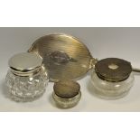 Three silver topped dressing table jars;