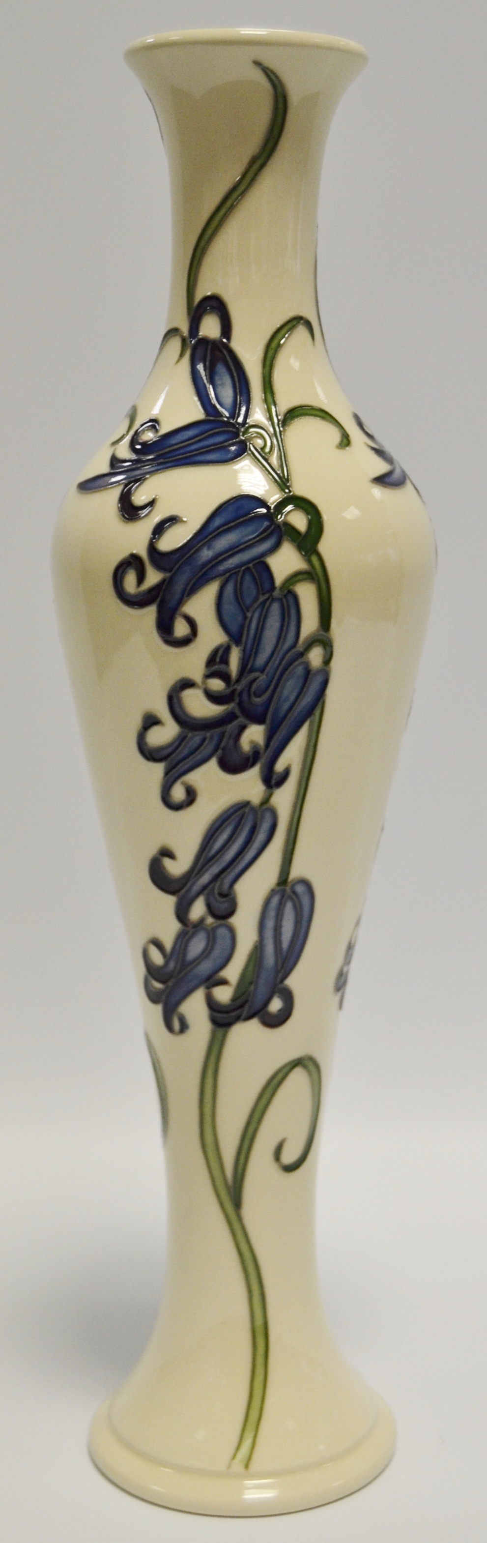 A contemporary Moorcroft slender ovoid vase, tube lined with blue harebells on a cream ground, 31.