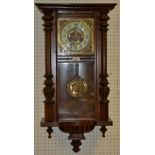 A mahogany Vienna wall clock, glazed door flanked by turned pilasters, brass face,