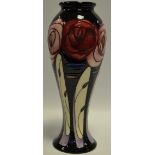 A contemporary Moorcroft Trial Rose pattern slender baluster vase,