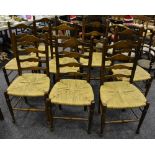 A set of eight oak ladder back dining chairs, rope seats,