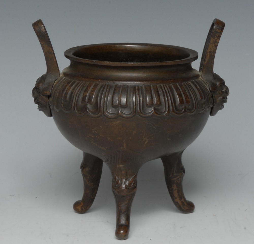 A 19th century Chinese bronze tripod censer, cast with a band of lotus,