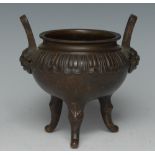 A 19th century Chinese bronze tripod censer, cast with a band of lotus,