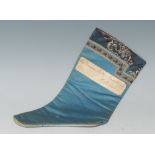 A 19th century Chinese silk dress slipper, typically worked in coloured silks, 27cm long,