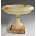 A 19th century alabaster table centre comport, saucer-shaped dish centred by a turned boss,