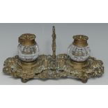 A 19th century bronze inkstand, cast throughout with fruiting vine, clear glass wells,