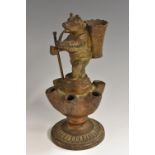 A 19th century cast iron novelty pipe stand/vesta, as a bear, he stands,