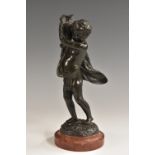 Clodion (19th century), a dark patinated bronze, of a scantily clad putto carrying a ewer,