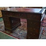 A reproduction mahogany twin pedestal desk