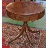 A Regency crossbanded mahogany drum table, turned column, sabre legs, brass lion paw feet,