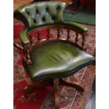 A mid 20th century mahogany and green leather captain's chair