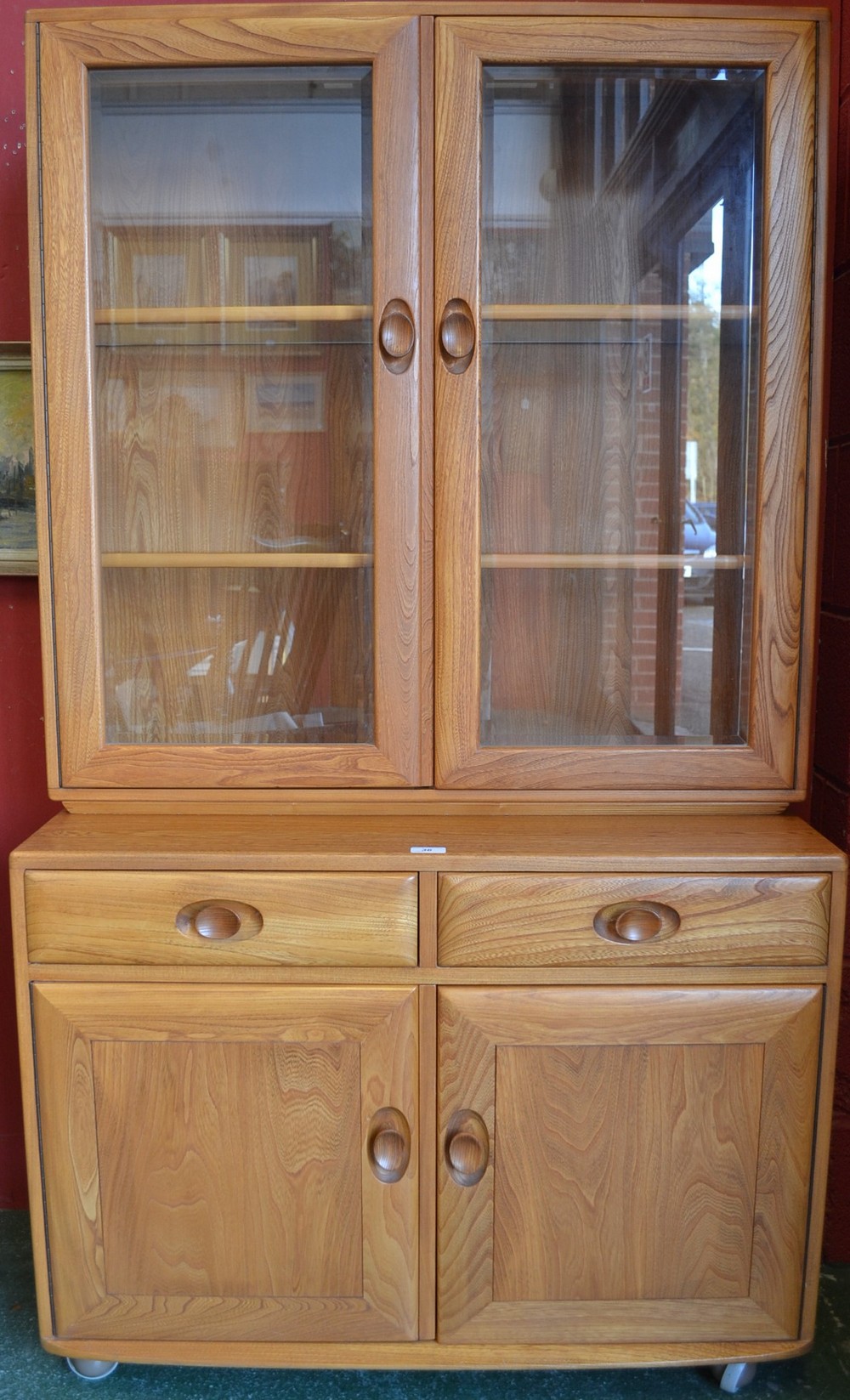 A light Ercol display cabinet,