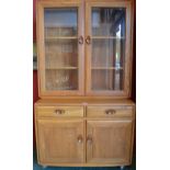 A light Ercol display cabinet,