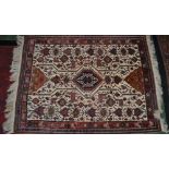 Carpets - a Persian style woollen rug, in shades of brown, blue, green and white, with birds,