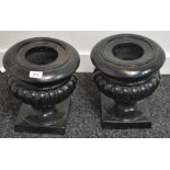 A pair of black painted lobed urns, everted rim, square base, 30cm high,